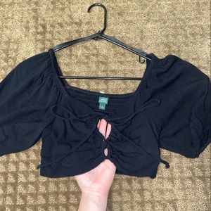 Cropped top with puffy sleeves and be worn multiple ways just out grew it